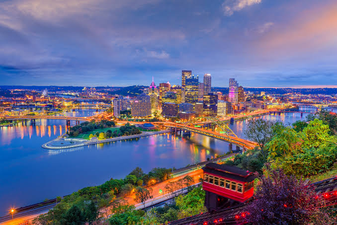 Pittsburgh skyline at dusk with the Duquesne Incline and three rivers, representing Allegheny County living